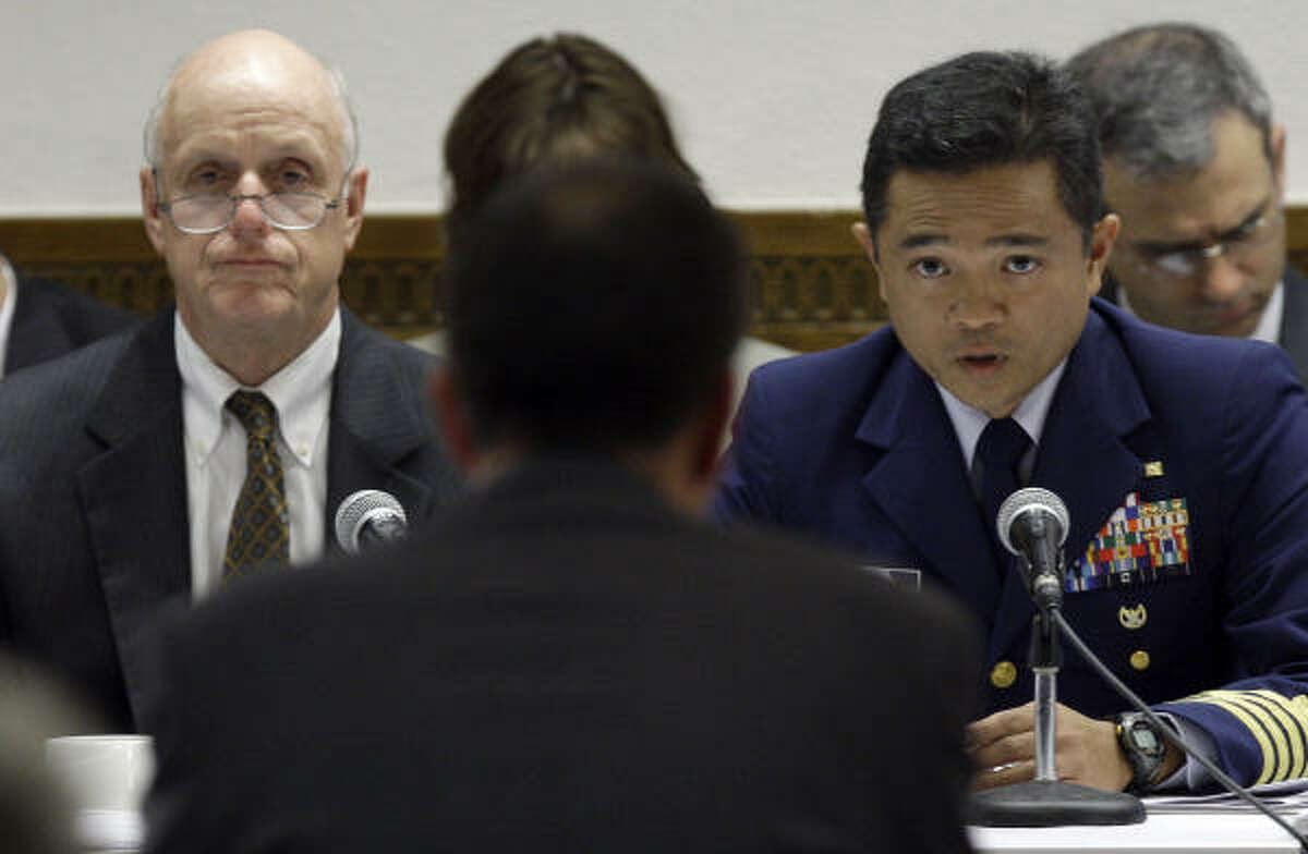 Transocean rig manager Paul Johnson, center, back to camera, testifies before a panel that includes U.S. District Judge Wayne Andersen, left, and U.S. Coast Guard Capt. Hung Nguyen, right, during the Deepwater Horizon joint investigation hearings by the U.S. Coast Guard and the Interior Department's Bureau of Ocean Management, Regulation and Enforcement on Monday, Aug. 23, 2010 in Houston.