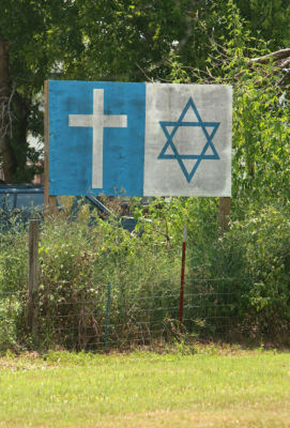 A sign bearing a cross and a Star of David was erected adjacent to the Muslim American Society's Katy Center.