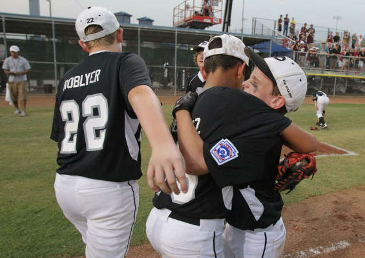 Pearland shortstop Jorge Gutierrez, center, gets a hug from teammate Caleb Maly moments after Thursday's win.