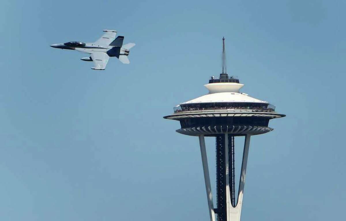 An EA-18G Growler passes the Space Needle during the Seafair Parade of Ships on Wednesday, August 3, 2011 on Puget Sound and along the Seattle waterfront.