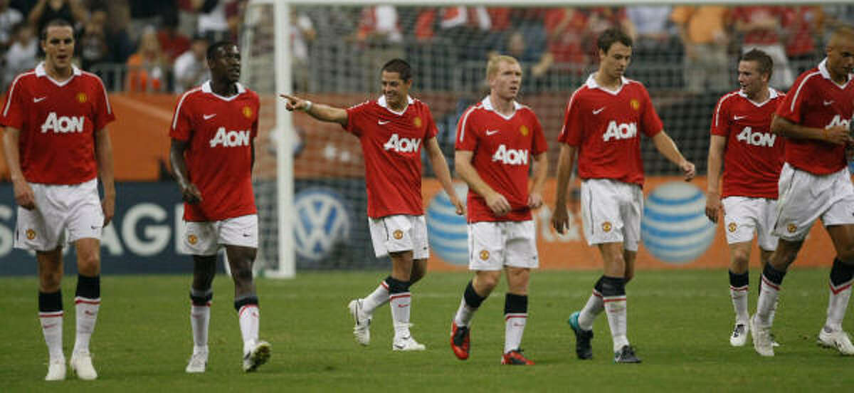 Manchester United 5, MLS All-Stars 2 Manchester United forward Javier "El Chicharito" Hernandez, center, celebrates with teammates after scoring his first goal for the club.