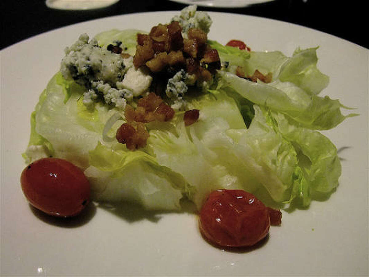The wedge salad with bacon, blue cheese & marinated tomatoes at The Barbed Rose. You choose your own dressing.
