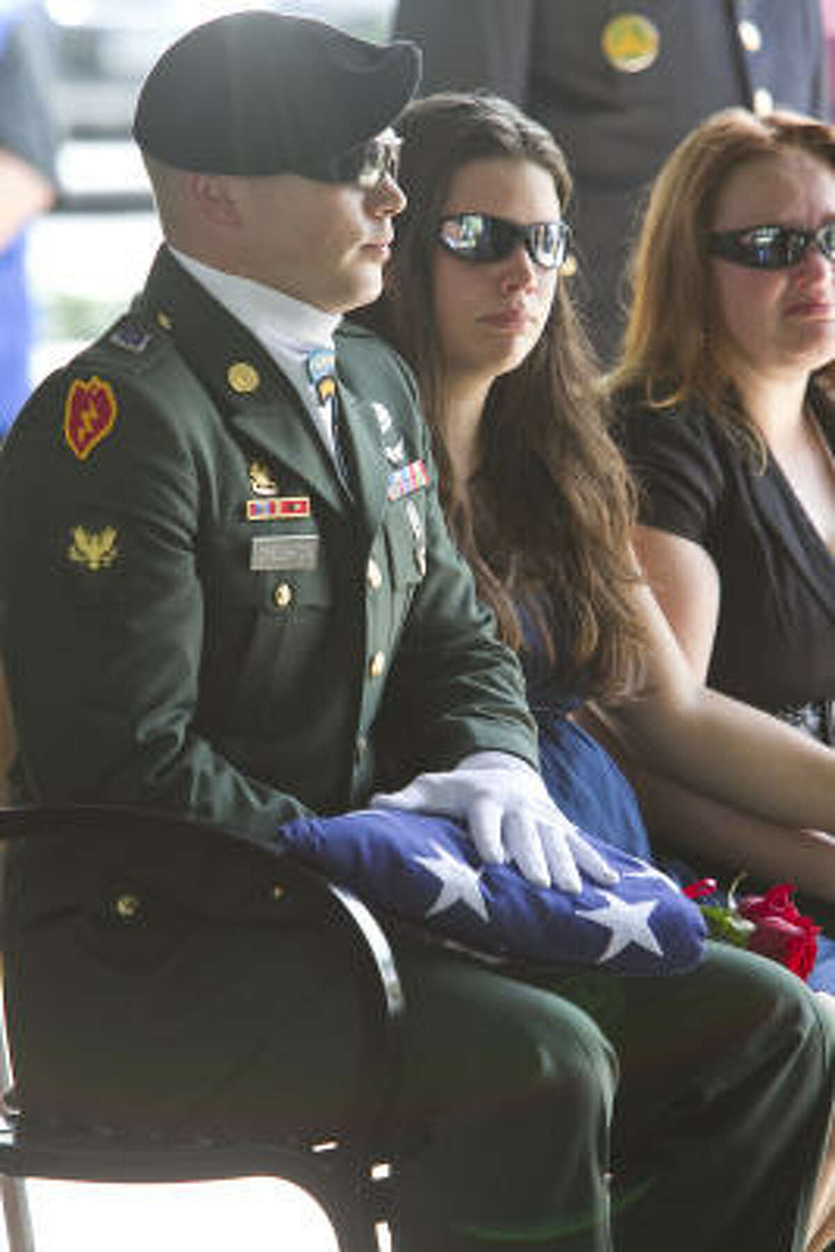 U.S. Army Spc. Allen Creighton is presented a flag for his brother Army Sgt. Andrew Creighton.