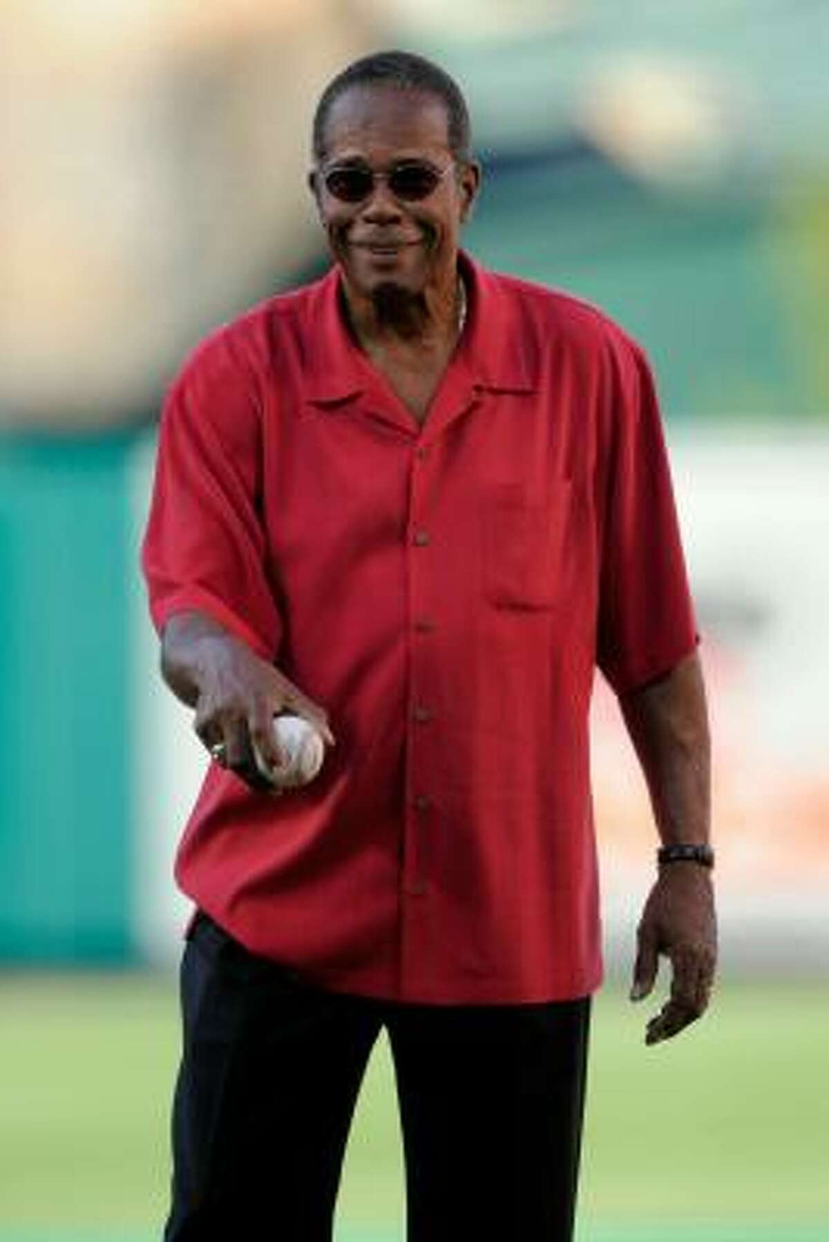 Baseball Hall of Fame member Rod Carew throws out the first pitch.