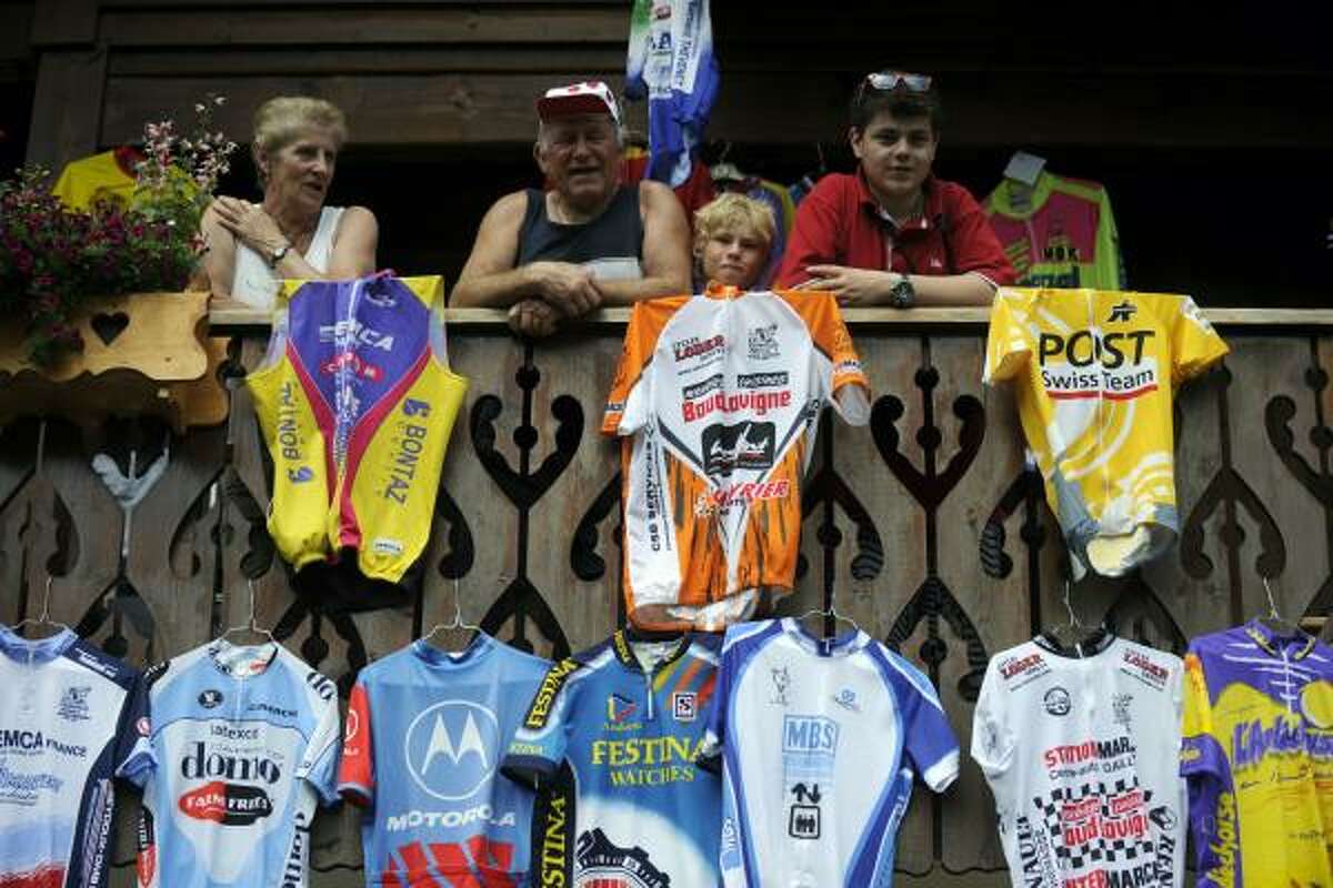 Jerseys are displayed on balconies of a wooden cottage as fans wait for riders in the 204,5 km and 9th stage of the 201 Tour de France.