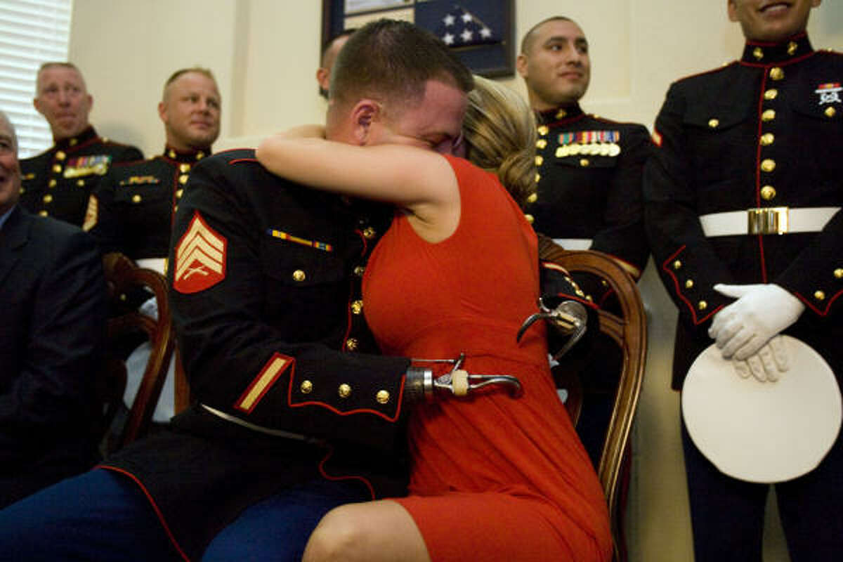 U.S. Marine Sgt. James "Eddie" Wright gets a hug and a "yes" after he proposed to his girlfriend Cody Fife .