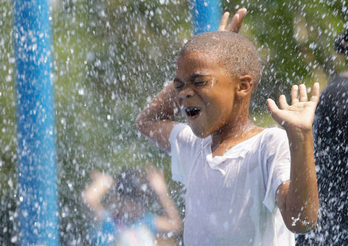 Alvin Merrite, 7, enjoys the water at the sprayground at Thomas R. Wussow Park, 500 Greens Rd. in Houston.