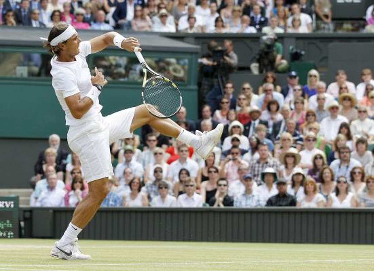Rafael Nadal makes a overhead return to Tomas Berdych.