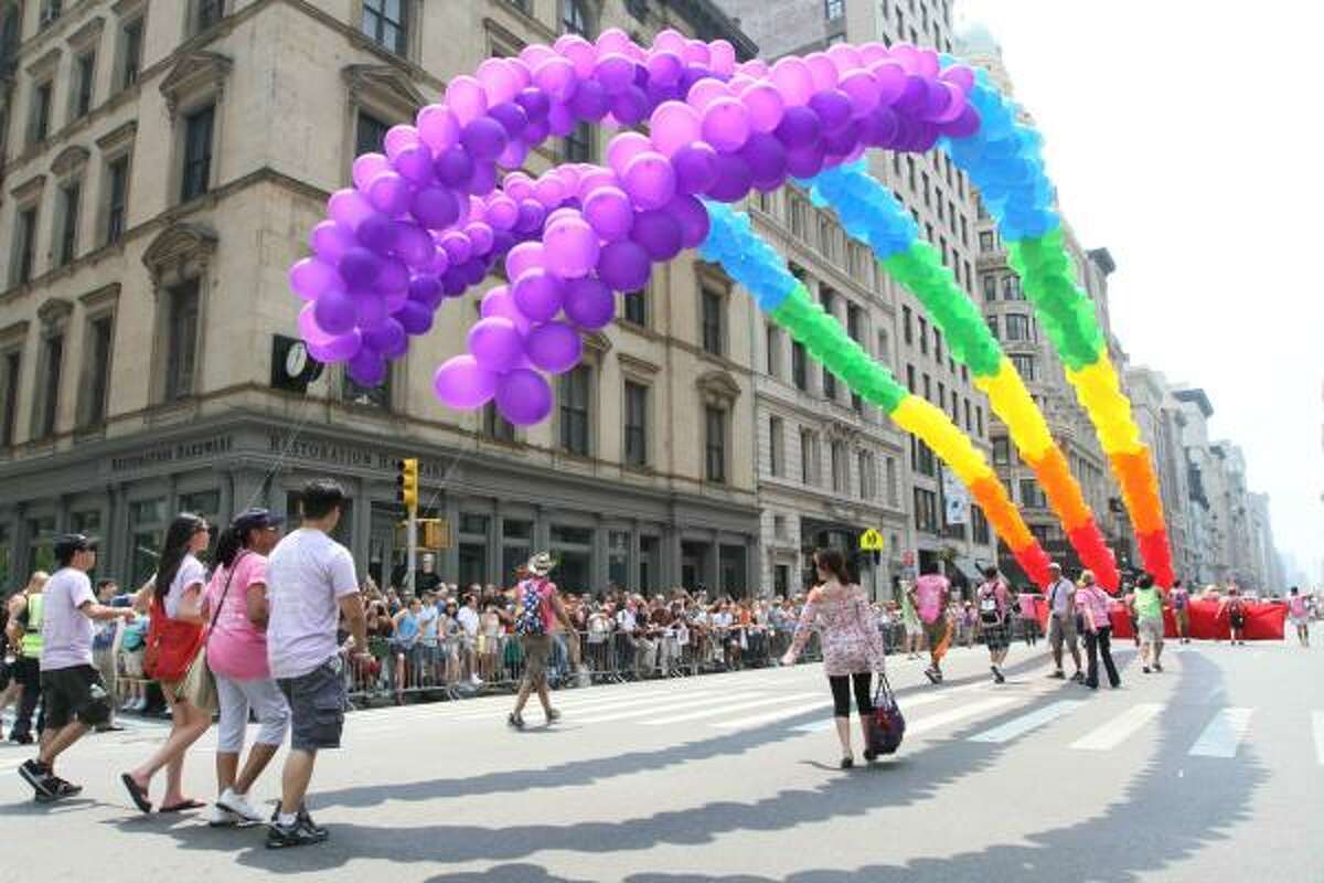 Strings of balloons are carried down New York's Fifth Avenue during the city's annual parade celebrating gay pride on Sunday, June 27, 2010 in New York.