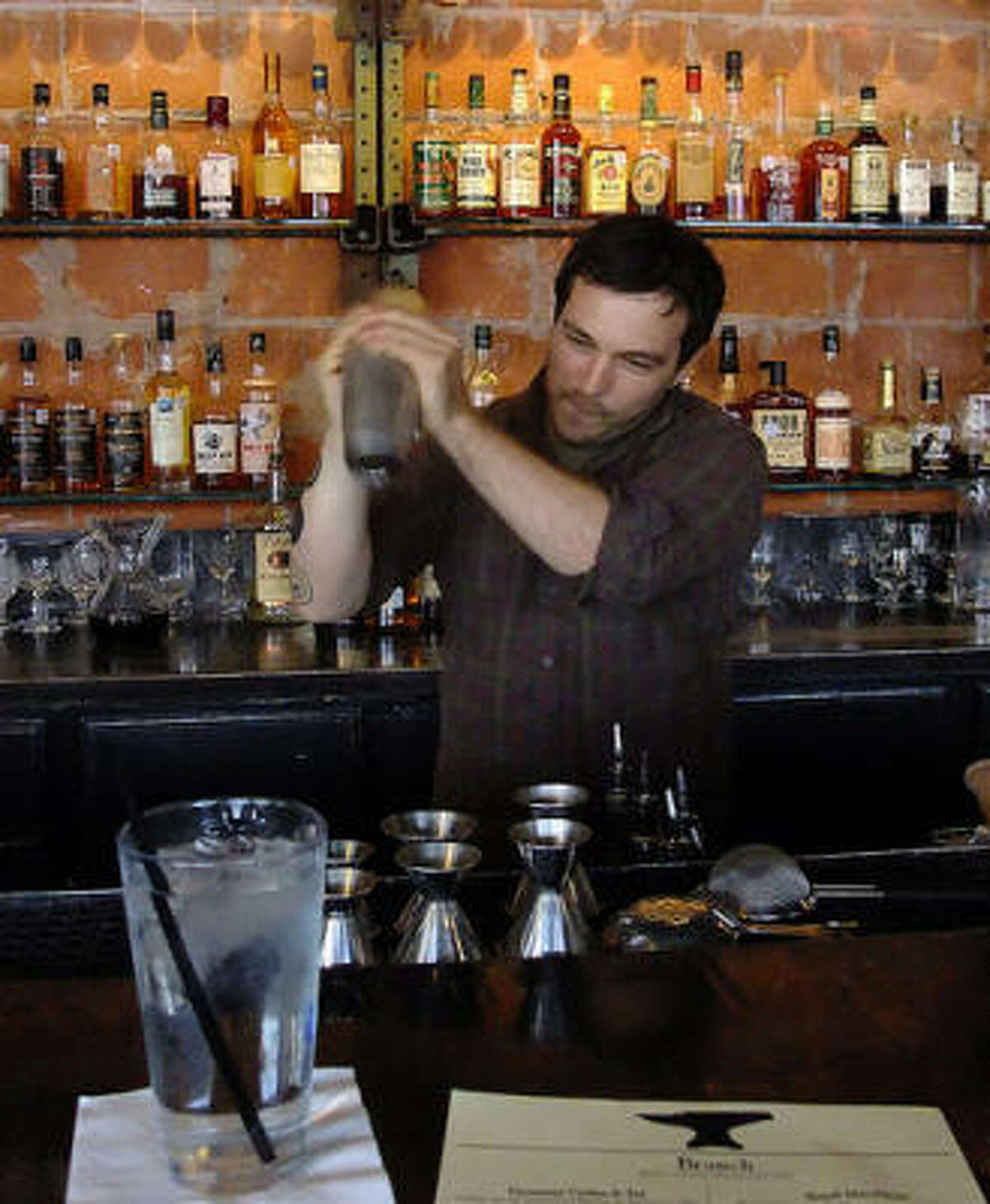 David Buehrer of Greenway Coffee and Tea guests behind the bar at Anvil's Sunday brunch, pouring hot coffee drinks and shaking cold coffee cocktails.