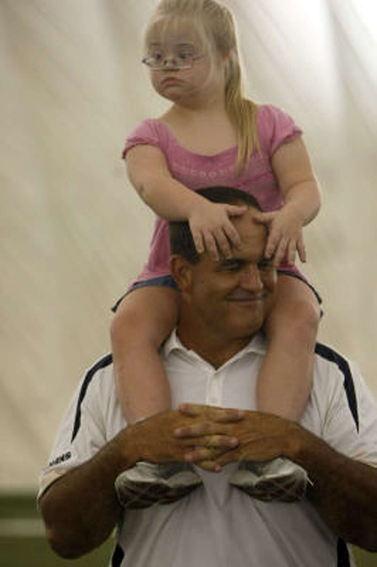 Bruce Matthews holds his daughter Gwen, 6, on his sholders while participating in the Houston Texans Second Annual All Pro Dad Father & Kids Experience.