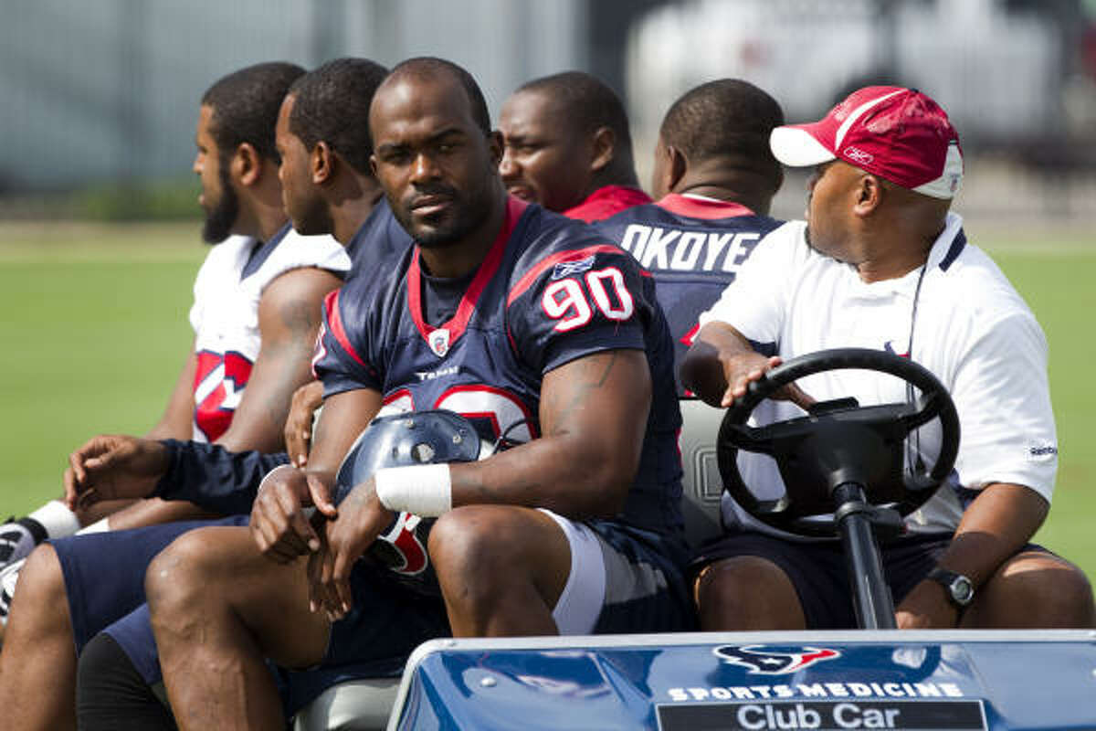 Texans defensive end Mario Williams gets a ride to practice with some teammates.