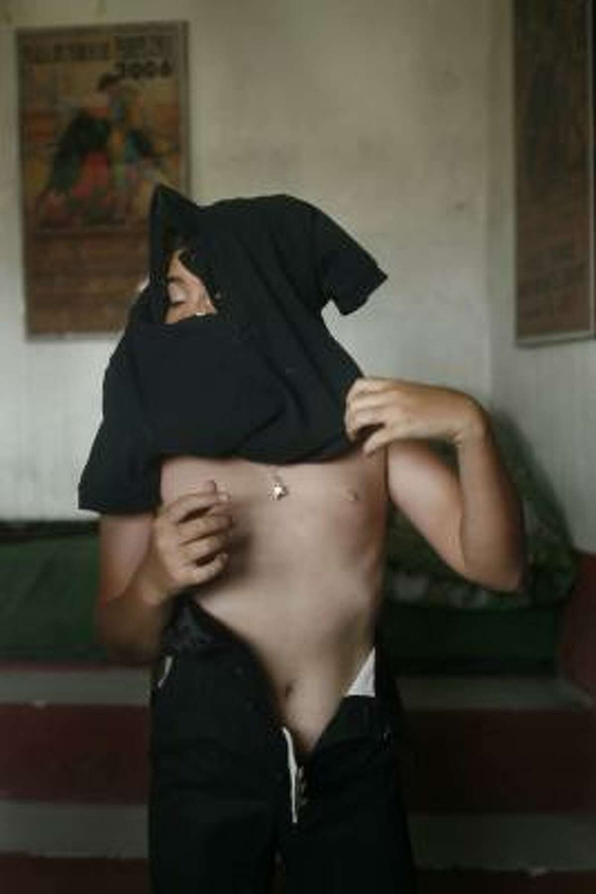 Franco-Mexican bullfighter Michel Lagravere, 12, known as Michelito, gets dressed before a bullfight practice session in Tlaxcala, Mexico, Saturday, June 5, 2010.