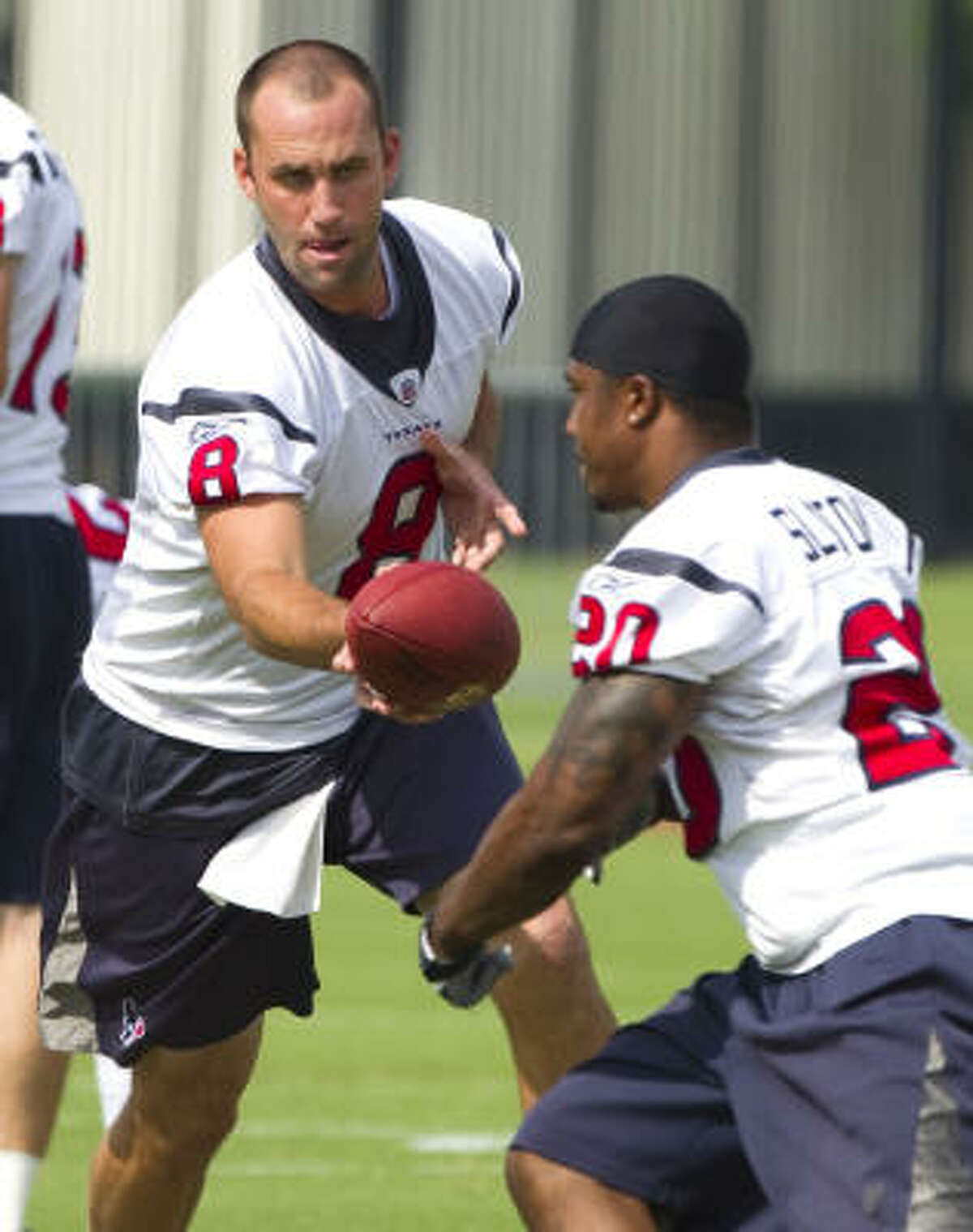 Texans quarterback Matt Schaub, left, hands the ball off to running back Steve Slaton.