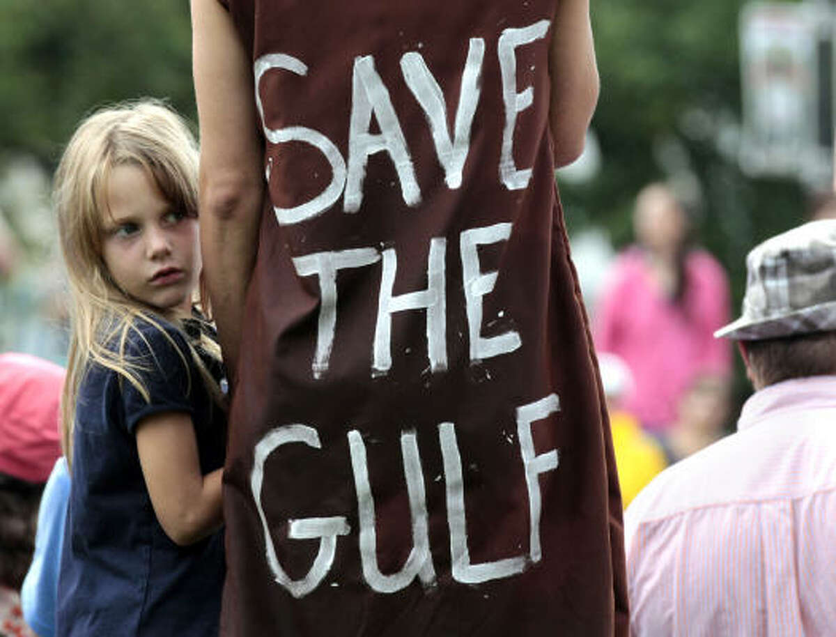 Jolie Van Gilder holds her mother's hand during a rally against BP and the Gulf oil spill Sunday in New Orleans.