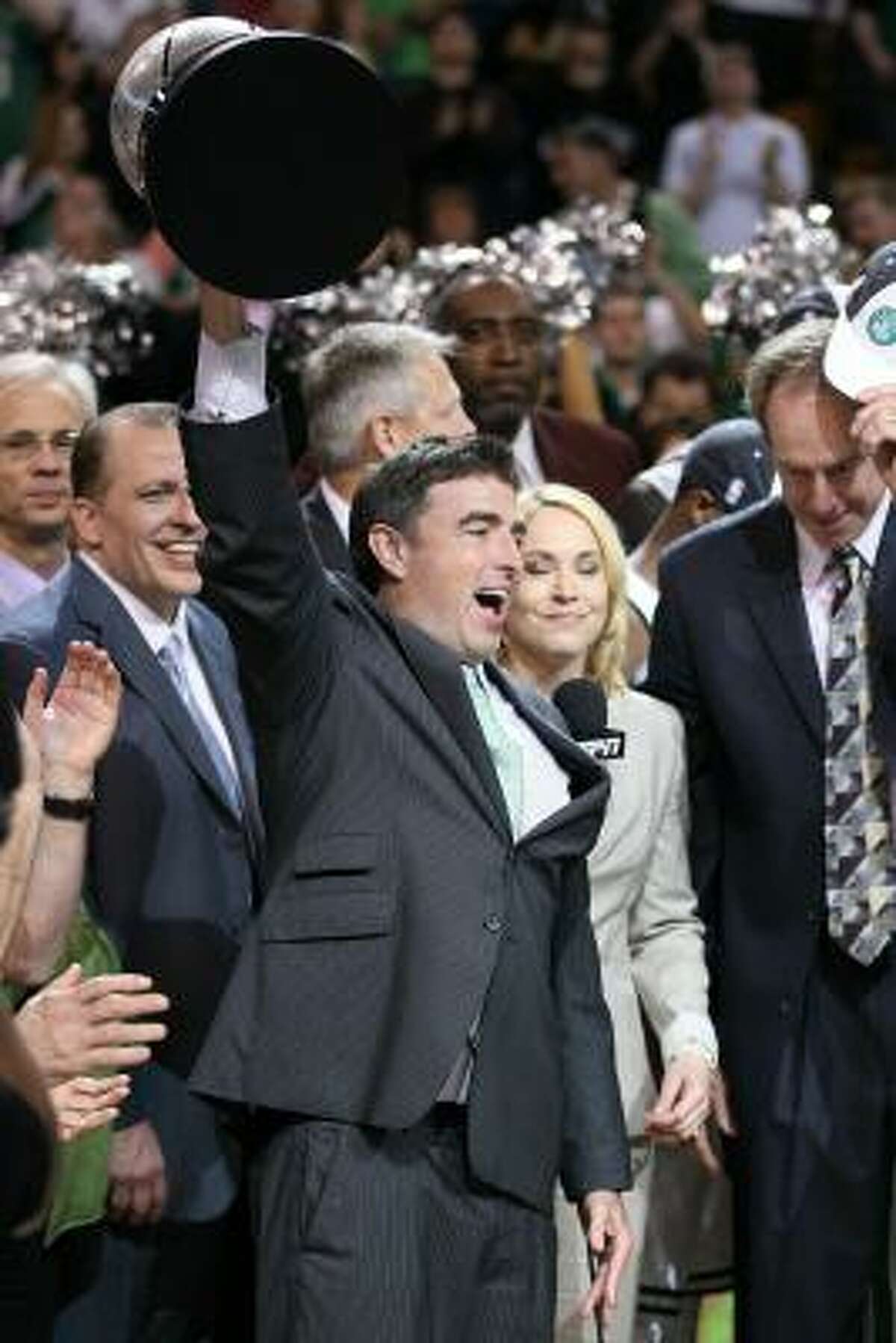Celtics owner Wyc Grousbeck hoists the Eastern Conference championship trophy.