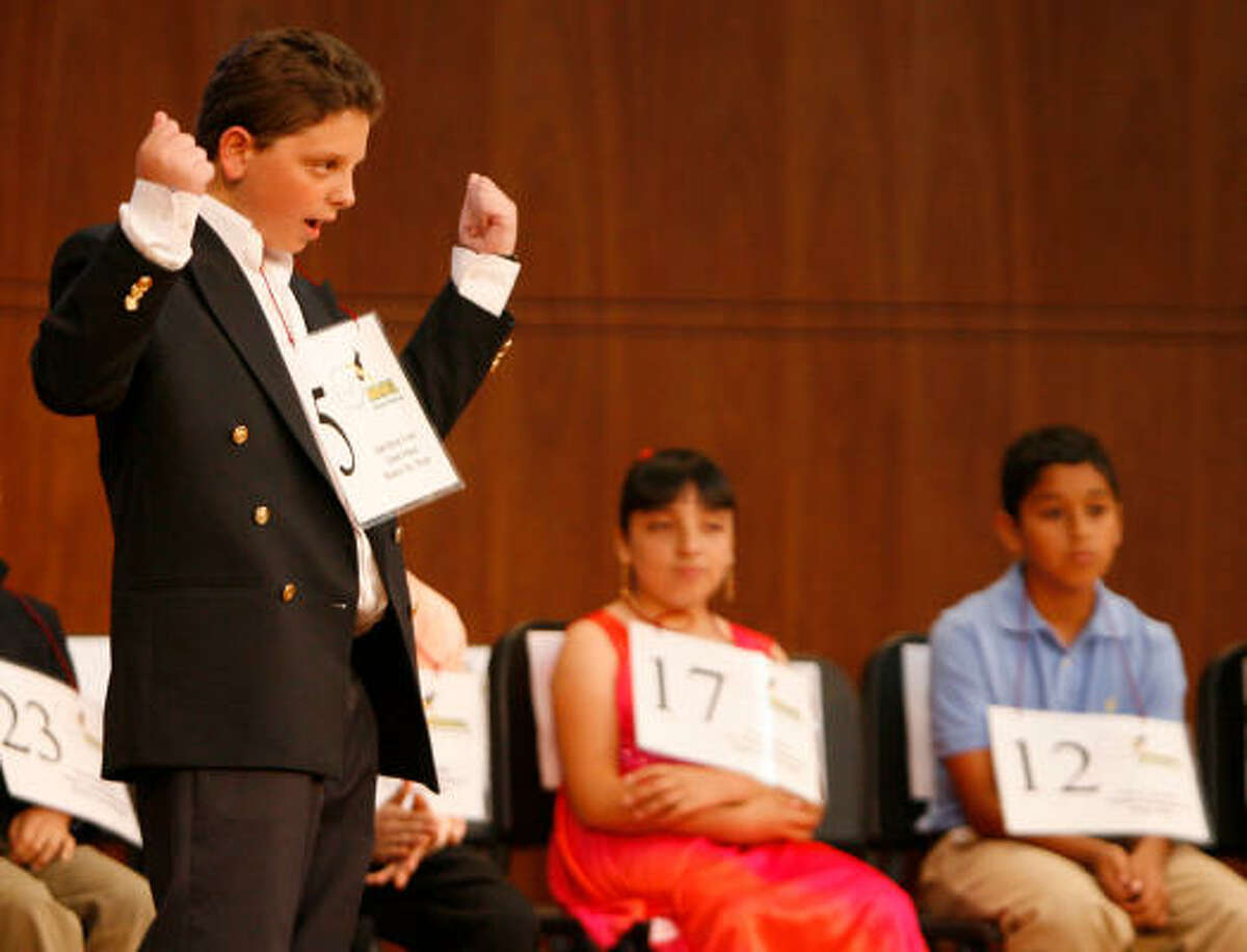 Isak Haras Green, of Eaton School in Mexico City, celebrates after spelling a word correctly in English and Spanish in the fifth round.