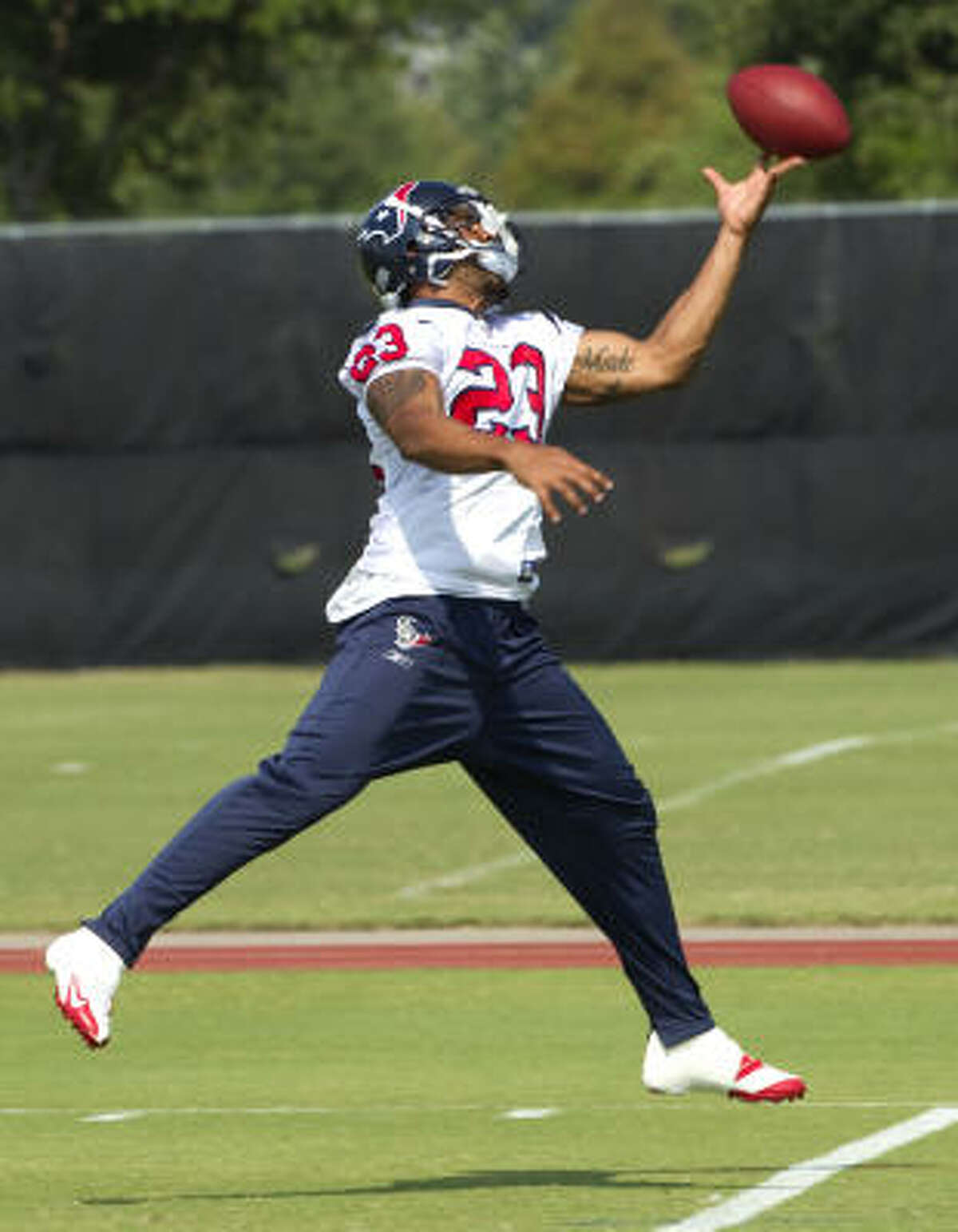 Texans running back Arian Foster reaches out for a ball.