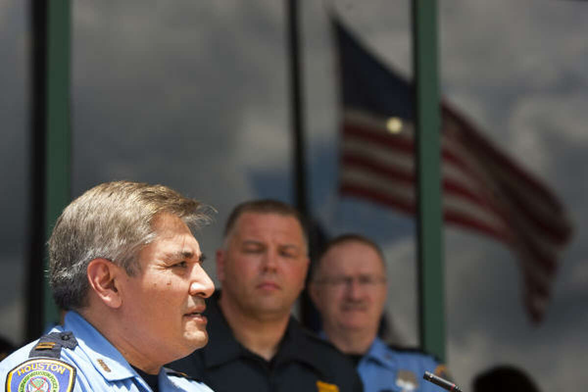 Houston Police Capt. Victor Rodriguez, center, speaks during a news conference announcing the death of HPD officer Eydelmen Mani Wednesday, May 19, 2010, in Houston. Mani, 30, was rushed to Memorial Hermann Hospital-The Texas Medical Center after crashing his squad car late Tuesday on the North Freeway feeder in north Houston.