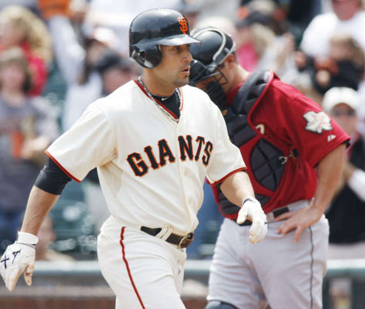 Giants left fielder Andres Torres heads for the dugout after hitting a home run during the first inning.