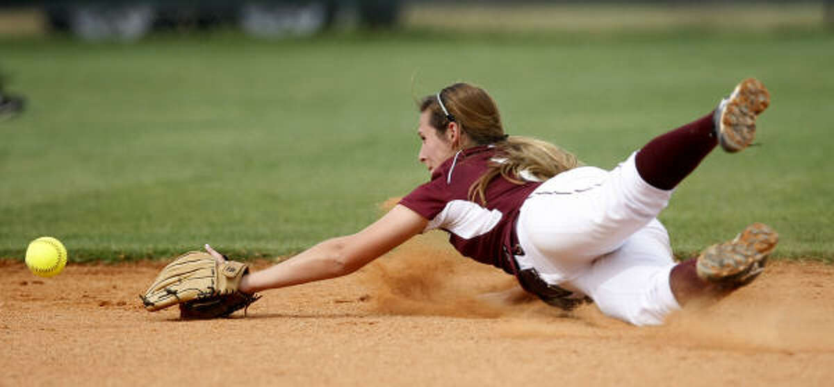 Cinco Ranch second baseman Rachel Moore is unable to make a stop on a grounder hit by Katy Taylor's Leslie Sheffy in the fifth inning.