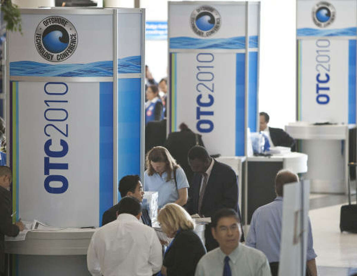Offshore Technology Conference attendees fill out paperwork to gain admittance to visit with more than 2,000 companies Monday, May 3, 2010, at Reliant Center in Houston. OTC includes attendees from around the globe, with more than 100 countries represented.