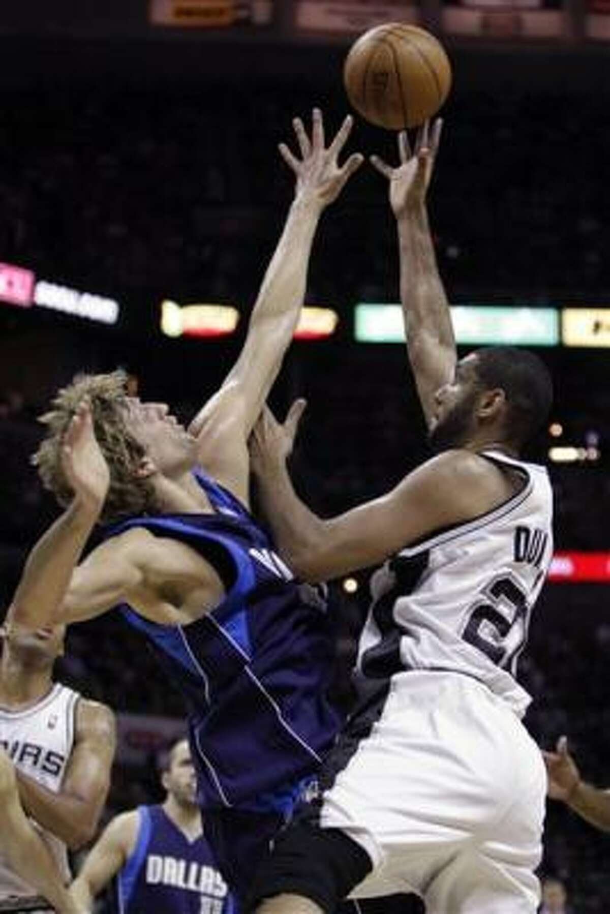Spurs' Tim Duncan, right, shoots over Mavericks defender Dirk Nowitzki during the first quarter of Game 6.