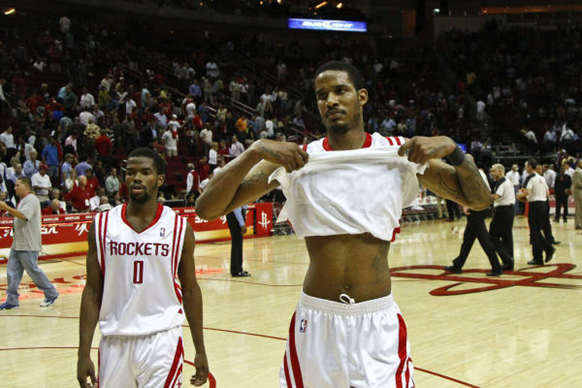 Rockets forward Trevor Ariza, right, and Rockets guard Aaron Brooks walk off the floor after losing 123-115 to the Hornets.
