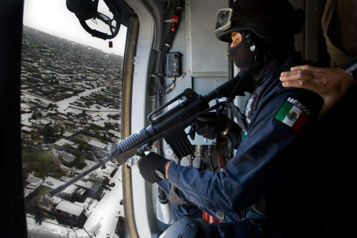 A police helicopter overflies Ciudad Juarez on patrol, on April 8, 2010. Some 5,000 federal police took over control of Ciudad Juarez on Thursday from thousands of soldiers who have failed to stem brutal gang killings in Mexico's most violent city. Up to 8,000 soldiers have been policing the border city since March 2008 under a controversial military crackdown on organized crime. Violent deaths have continued almost daily however, with more than 2,600 recorded in 2009 alone, and thousands of residents have fled the border city across from El Paso, Texas.