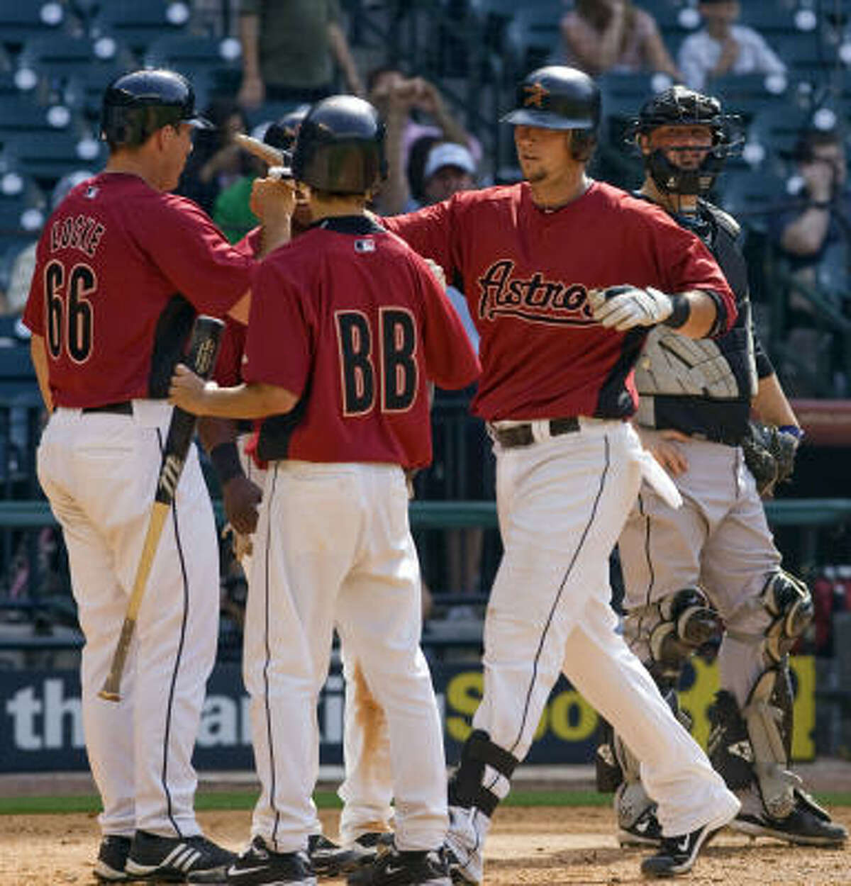 Houston's Chris Johnson, right, is congratulated by teammate Andrew Locke after hitting a home run in the ninth inning.