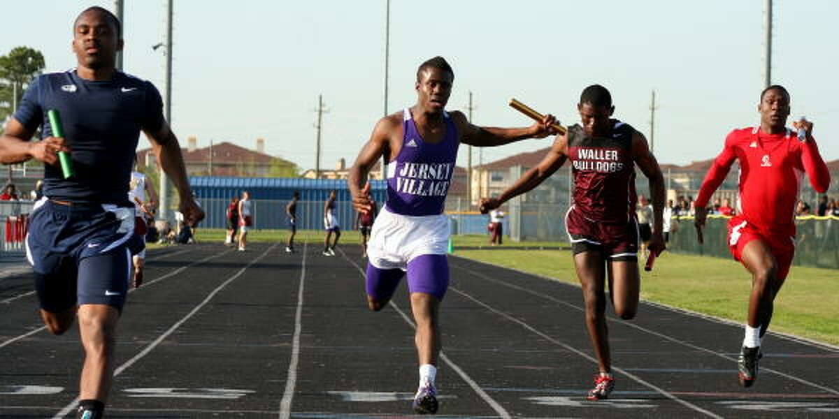 The boys lean at the tape in the 400-meter relay.