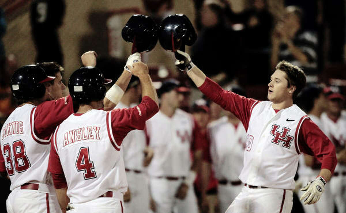 UH's Codey Morehouse, right, is congratulated by M.P. Cokinos (38) and Joel Ansley after hitting a three-run homer in the fifth inning.