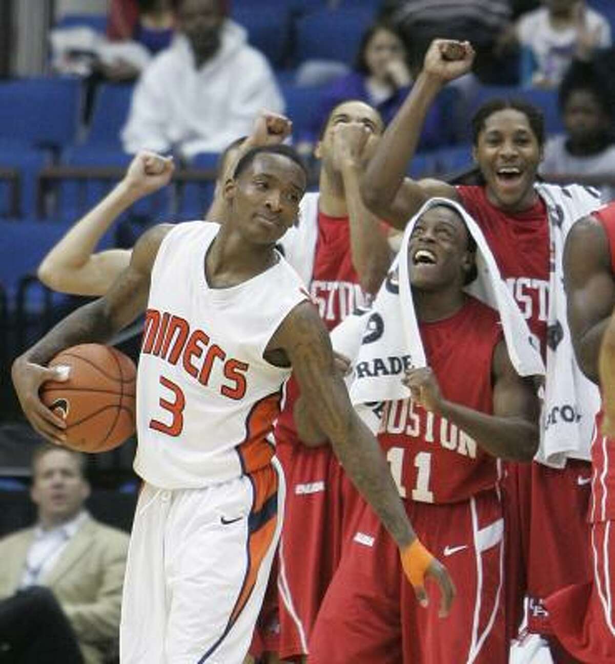 UTEP guard Randy Culpepper holds the ball as the Houston bench cheers at rear, following a whistle in the closing minutes of the Conference USA men's championship NCAA college basketball game in Tulsa, Okla., Saturday, March 13, 2010. Houston won 81-73.