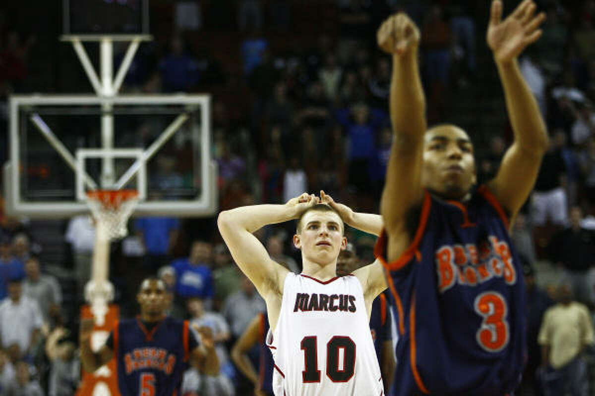 Marcus' Phil Forte (10) crosses his fingers as Bush's Rodshard Davis sinks a free throw to snap a 43-43 tie with 1.3 seconds left in overtime.