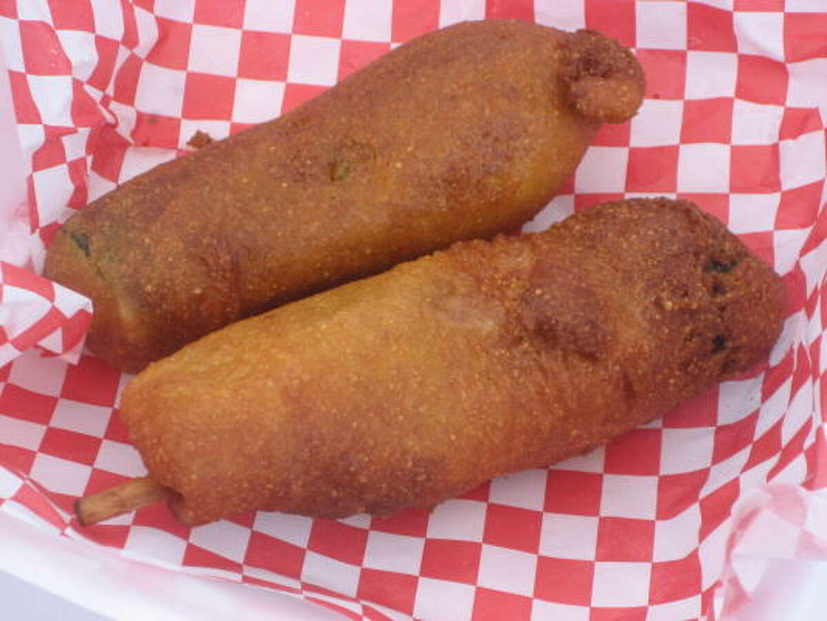 Battered and deep fried zucchini stuffed with a hot dog on a stick.