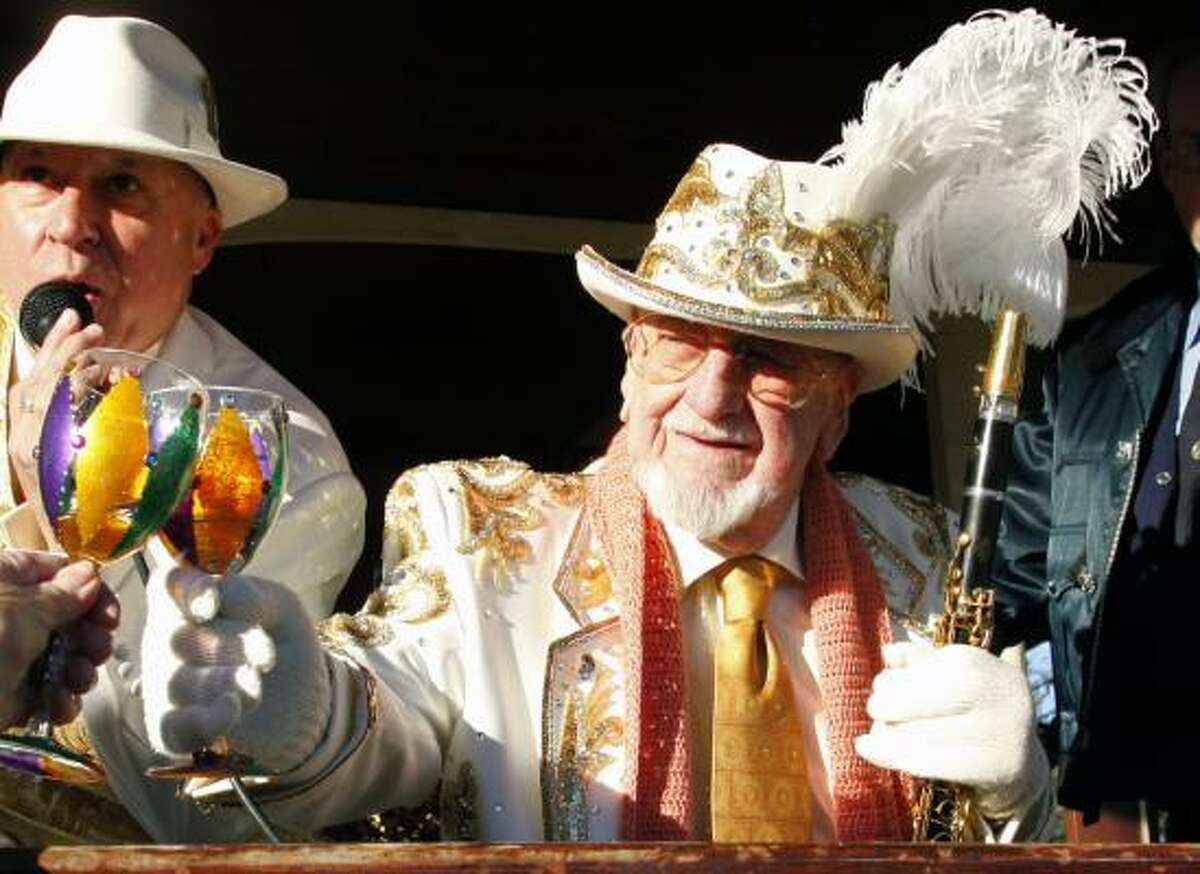 Pete Fountain gives a toast as he leads his Half Fast Walking Club through the streets of New Orleans, Tuesday. This is the 50th year Fountain has led his group celebrating the all day street party of Mardi Gras.