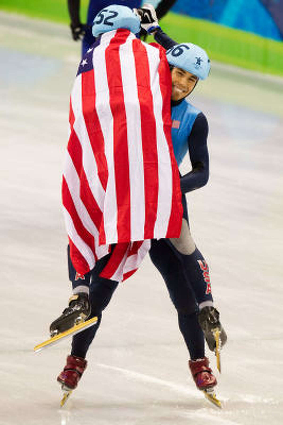 Apolo Anton Ohno lifts up teammate J.R. Celski in celebration after capturing his sixth Olympic medal with a second-place finish in the men's 1500 meters. Celski captured the bronze medal.