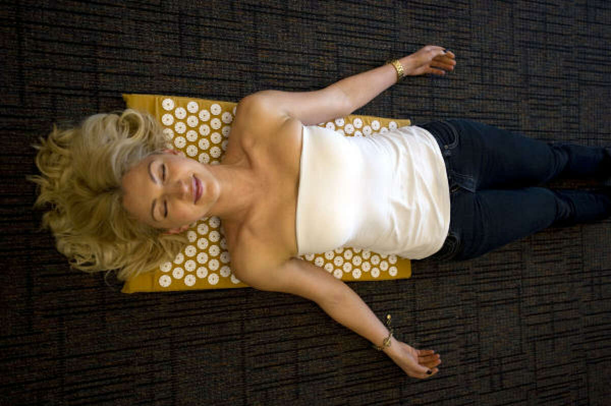 Olena Sholomytska demonstrates one of the mats that are a sensation in Sweden. The mat is embeded with sharp plastic spikes, which are said to stimulate pressure points to reduce stress, and acheive deep relaxation.
