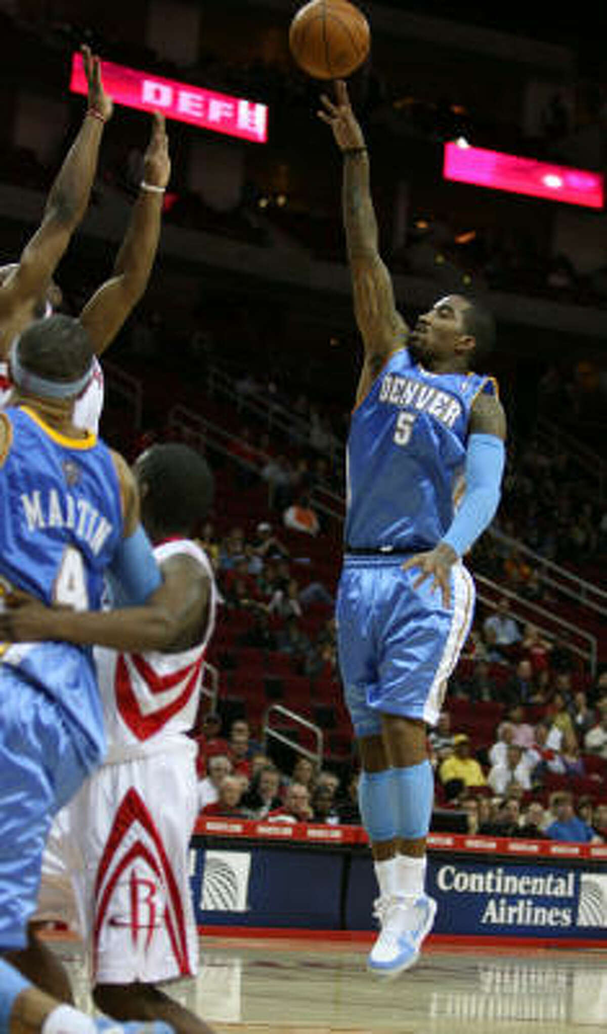 Nuggets guard J.R. Smith sends a shot over the Rockets' defense.