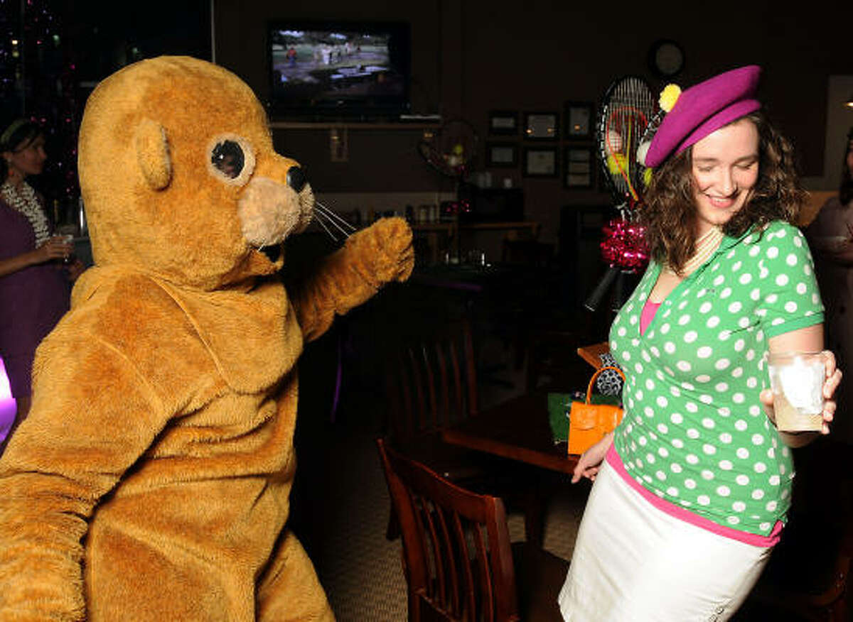 Cynthia Conner, at right, dances with the gopher, a.k.a. Jenni Rebecca Stephenson at the "Be the Ball" annual benefit supporting Glasstire and Fresh Arts Coalition at the Hermann Park Golf Course.