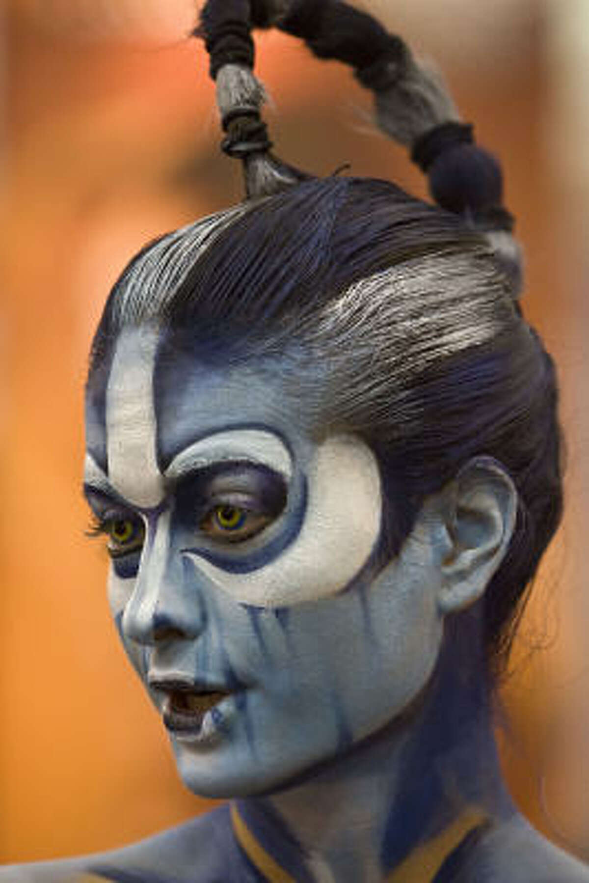 Sindy Perez is painted to resemble a character from the movie Avatar during the Halloween & Party Expo at George R. Brown Convention Center, in Houston.
