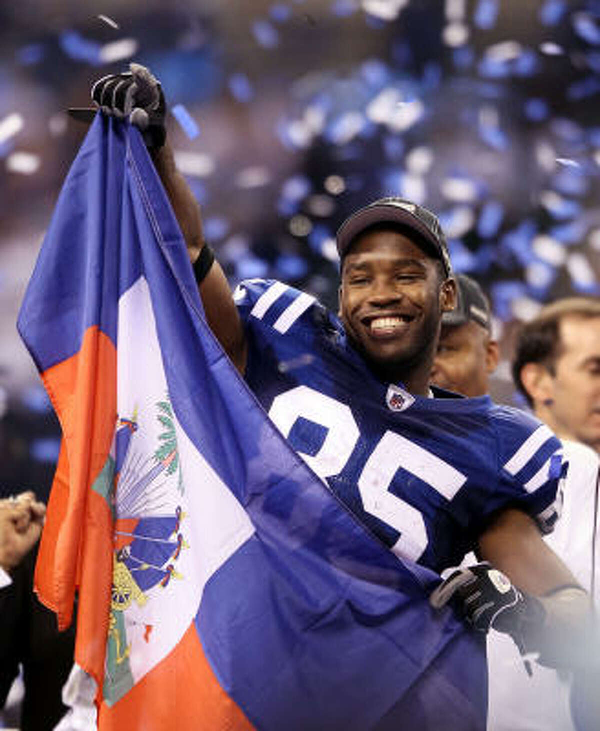 Colts receiver Pierre Garcon celebrates with the Haitian flag after the game. Garcon, of Haitian origin, caught 11 passes for 151 yards.