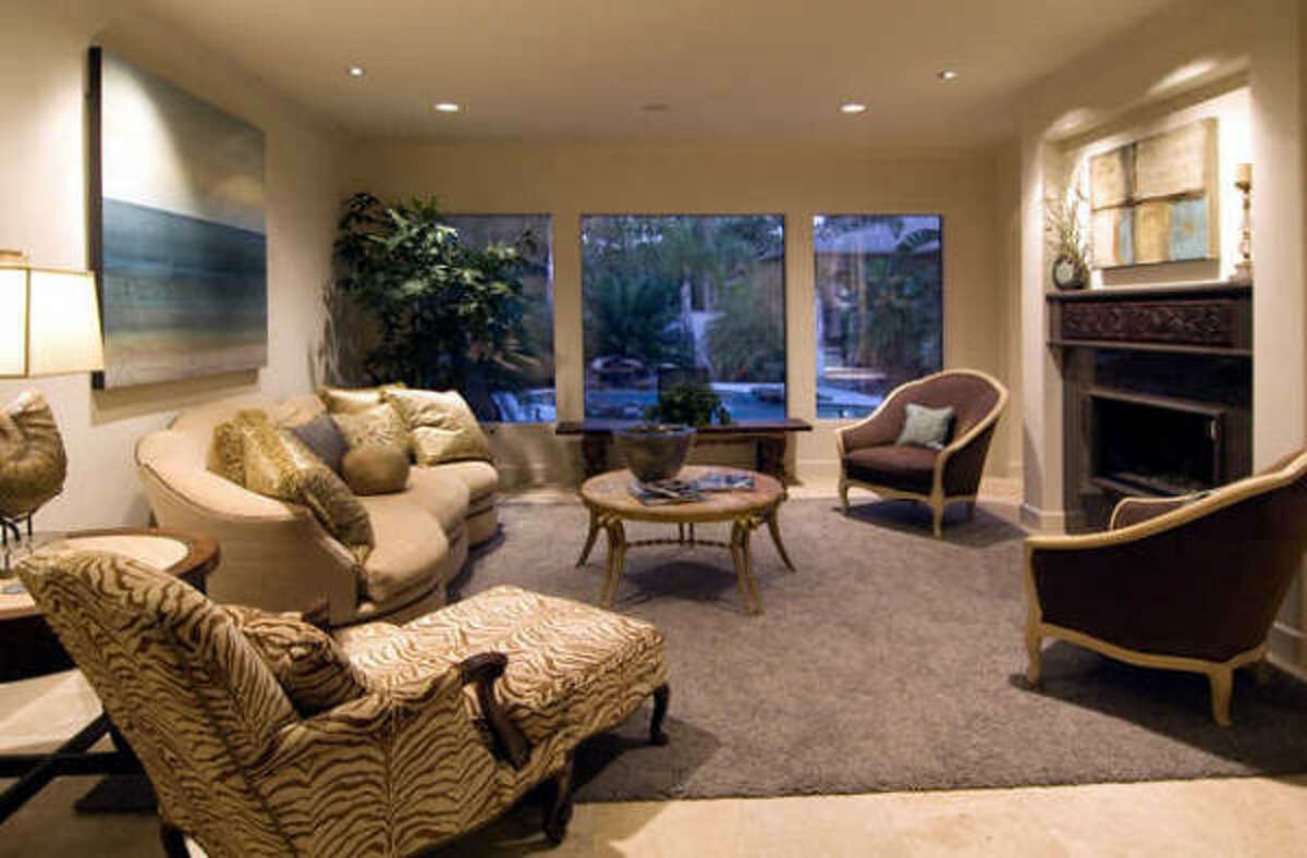 Living room (18 X 18) with a series of floor to ceiling windows viewing the laguna style pool and landscaped backyard.
