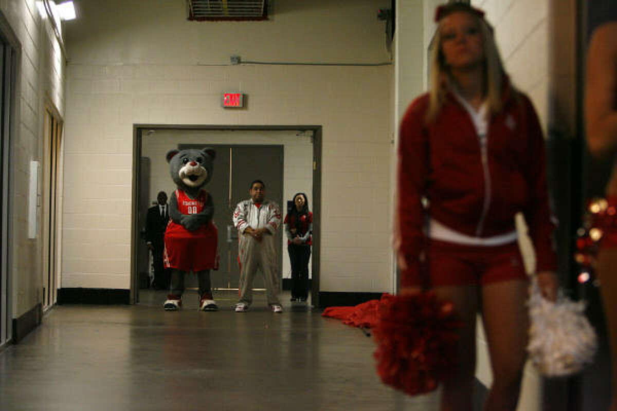 Clutch, aka, Robert Boudwin, the Houston Rockets mascot, stands in the tunnel with his sidekick Dominic as the National Anthem played before a game against the Miami Heat at the Toyota Center.