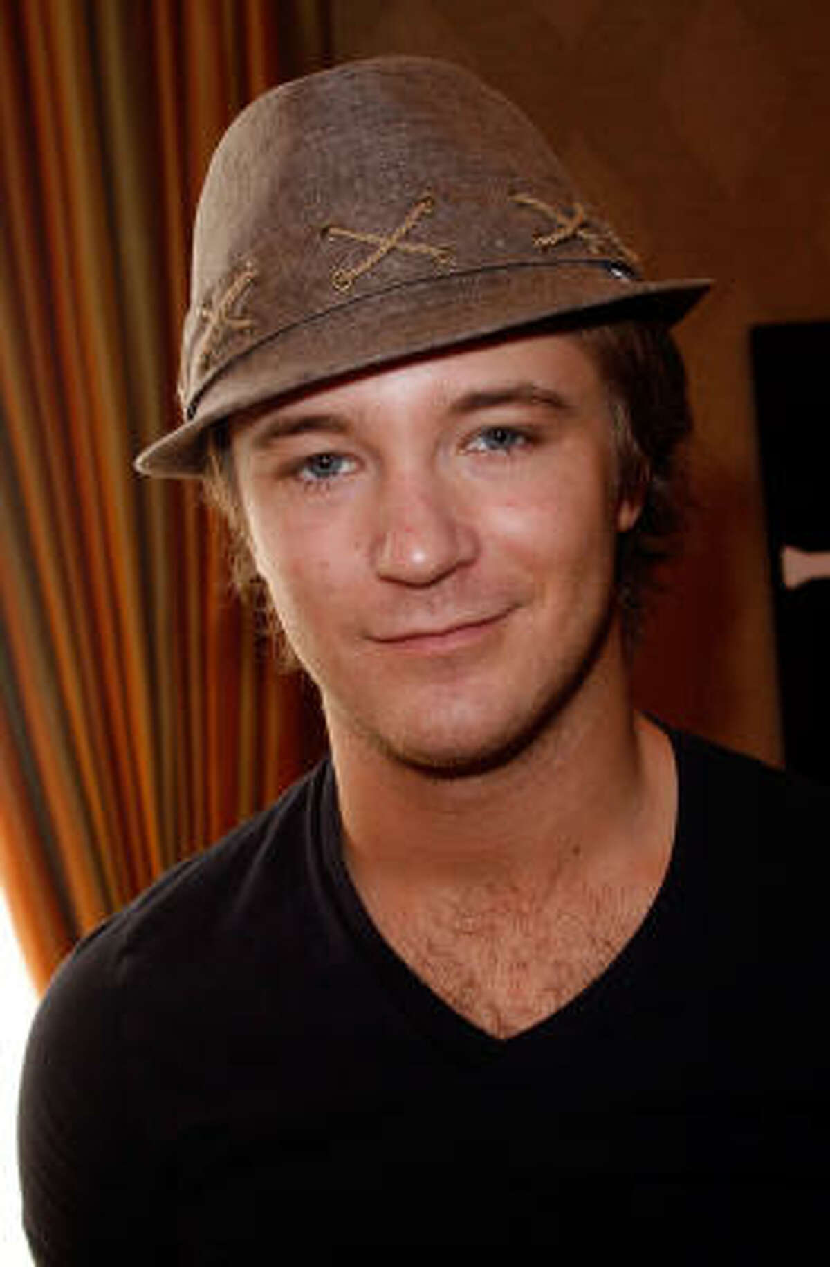 Twilight 's Michael Welch poses at the Block Headwear display during the HBO Luxury Lounge.