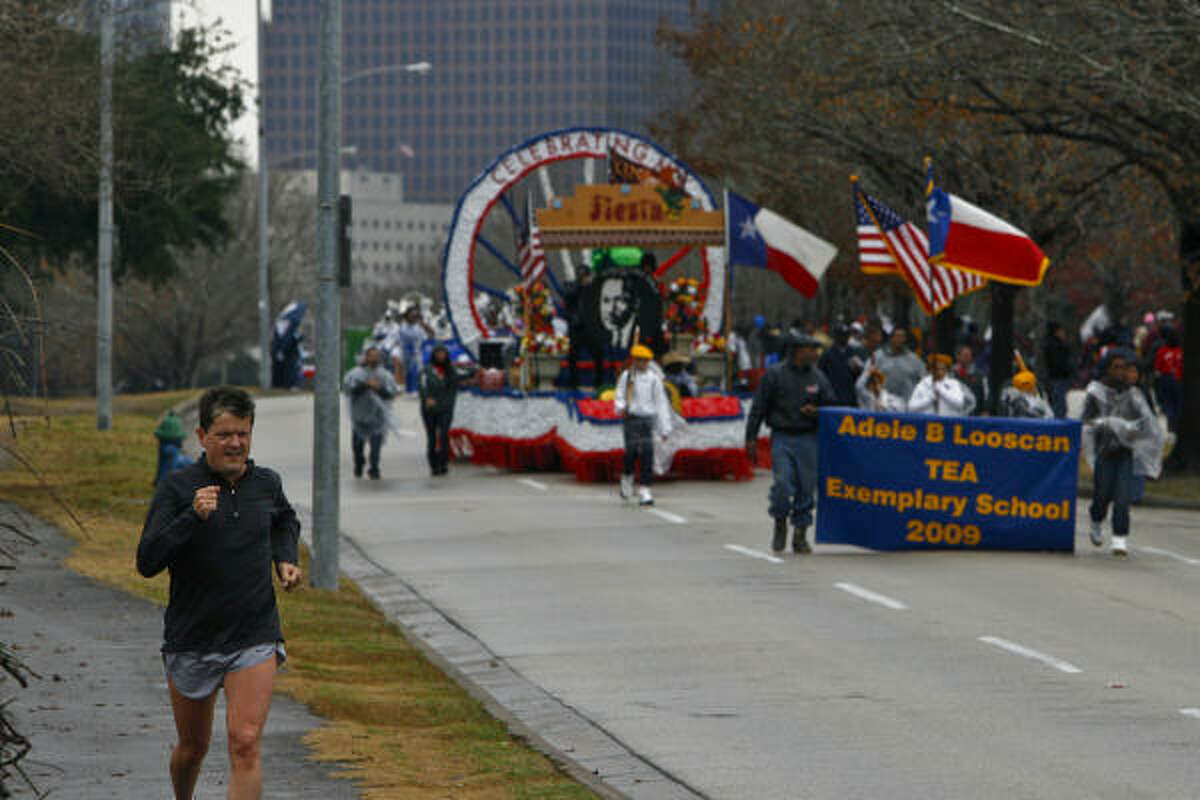 An unidentified runner passes through the parade route.