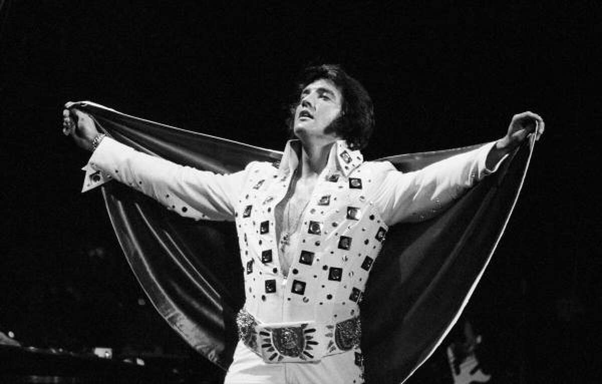 Paganism :His bejeweled jumpsuits were covered with “occult” symbols: horseshoes, owls, crosses, zodiacs. Here, at Madison Square Garden, he’s rockin’ an ankh necklace and a belt so tacky I can’t tell what’s on it.