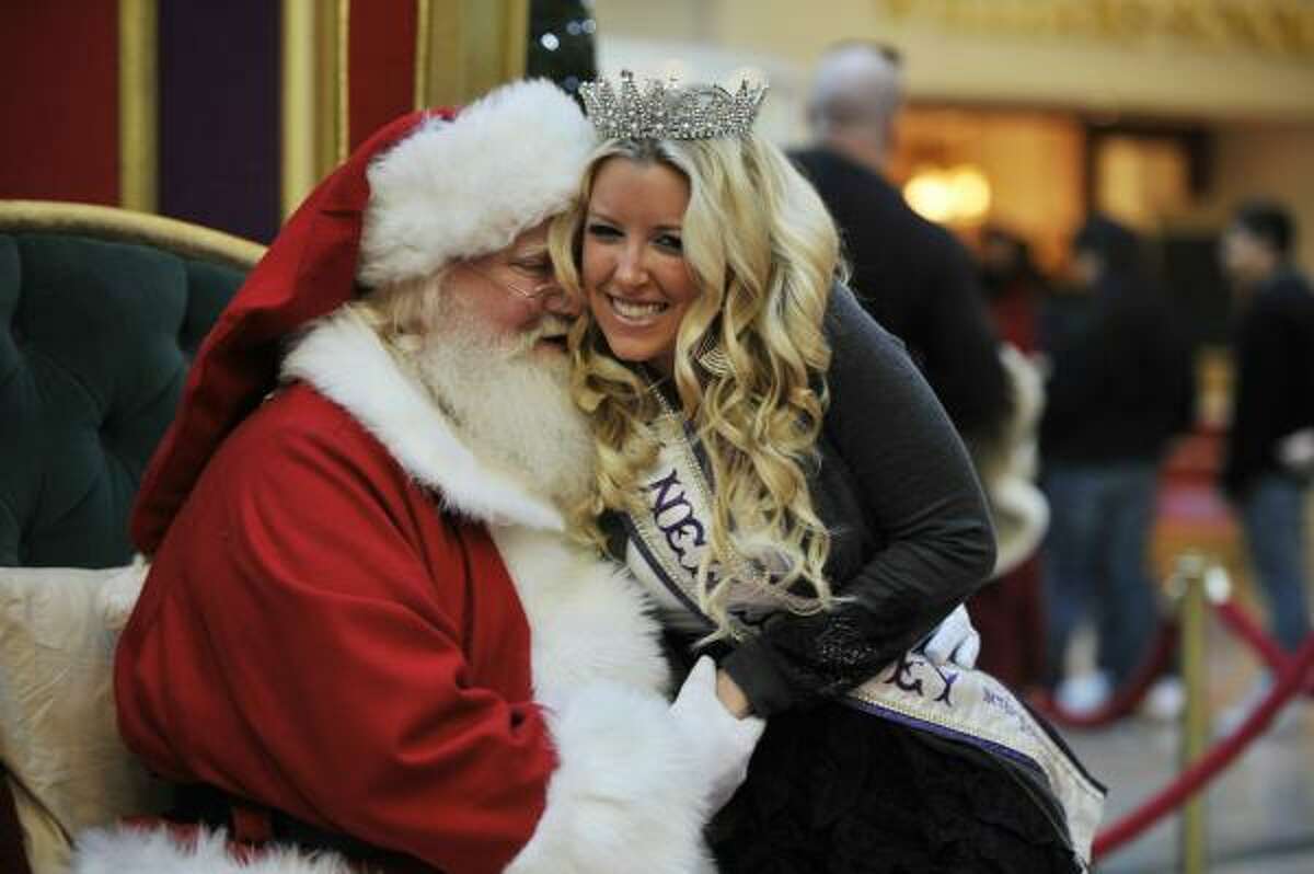 Miss New Jersey, Brielle Lacosta of Warren Twp., NJ gets a big hug from Santa Claus as she sits with him at the Bridgewater Commons Mall in Bridgewater TWP, New Jersey. Having finished her shopping, Ms. Lacosta said she wanted to visit with Santa and get her picture taken.