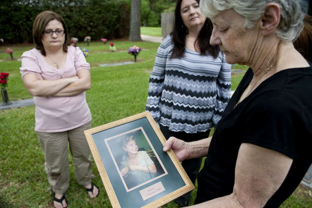 Sisters Kelly Hancock, left, Barbara Wilson and Kim Edwards are still waiting for police to catch the person who killed Wilson's daughter, Kristen Lea Wilson, in November 1996. Her parents found Wilson, 29, slain in her southwest Houston apartment.