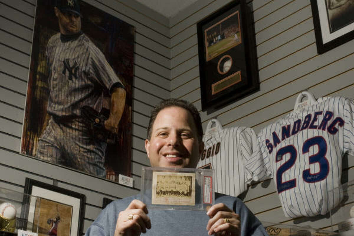 Houstonian Jeffrey Rosenberg holds an 1869 card picturing baseball’s first pro team, the Cincinnati Red Stockings, which he won in an eBay auction. Fewer than 10 are known to exist.